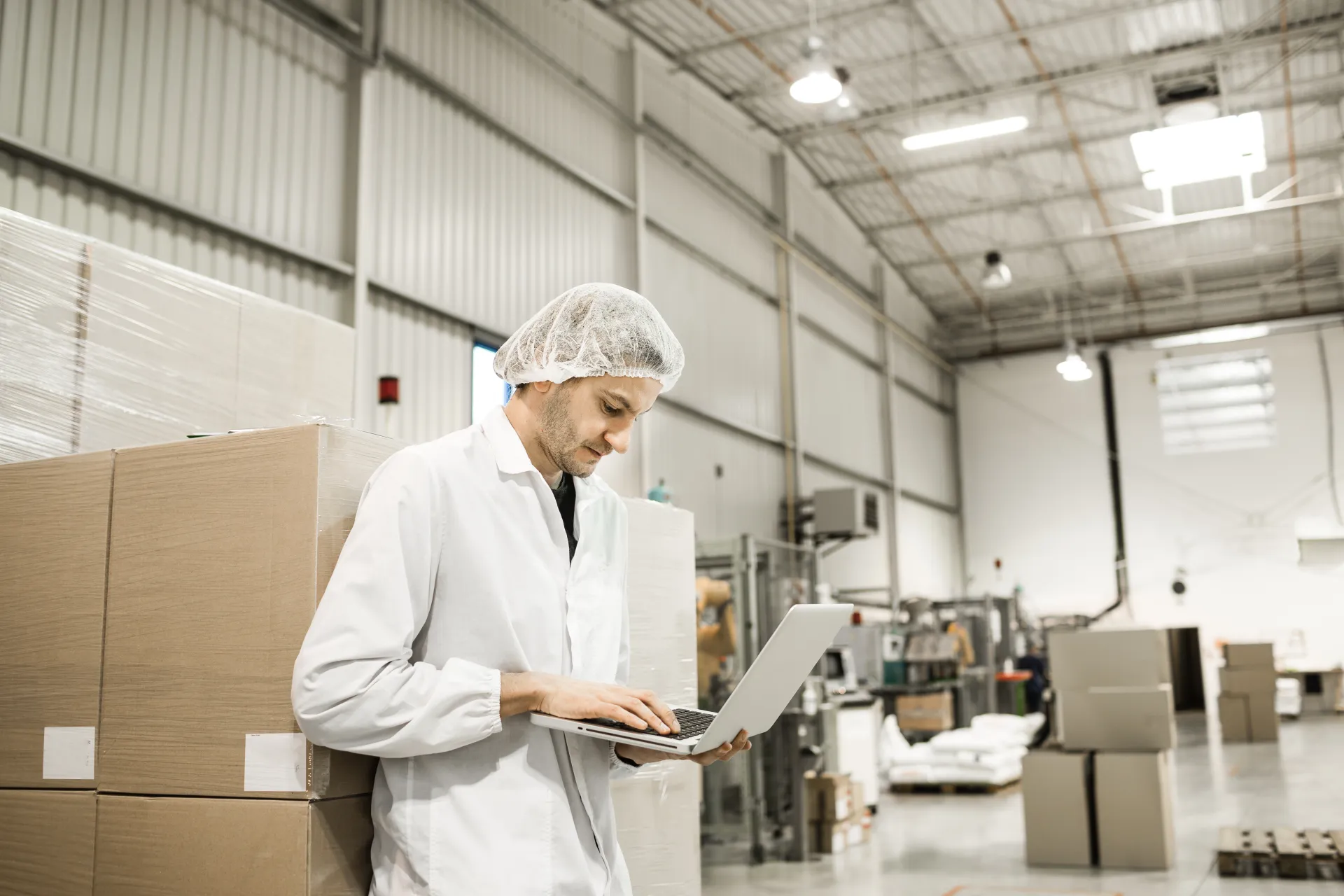 man in lab coating checking quality clipboard factory qc